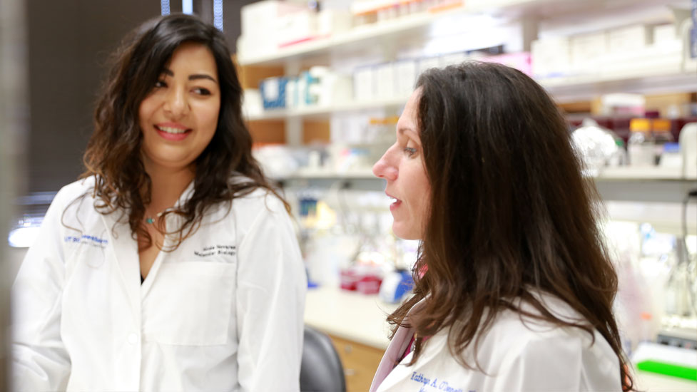 Two female students talking in the lab